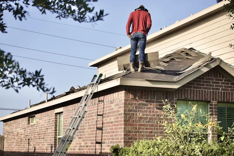 Professional roofer working on a residential roof in Jarrettown